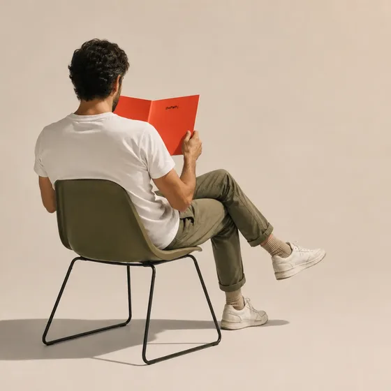 A person seated with their back to us, reading The Path.